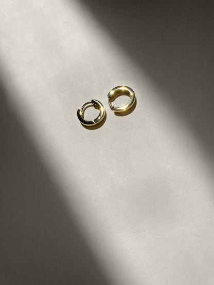 Gold hoop earrings, close-up and lightweight and brushed